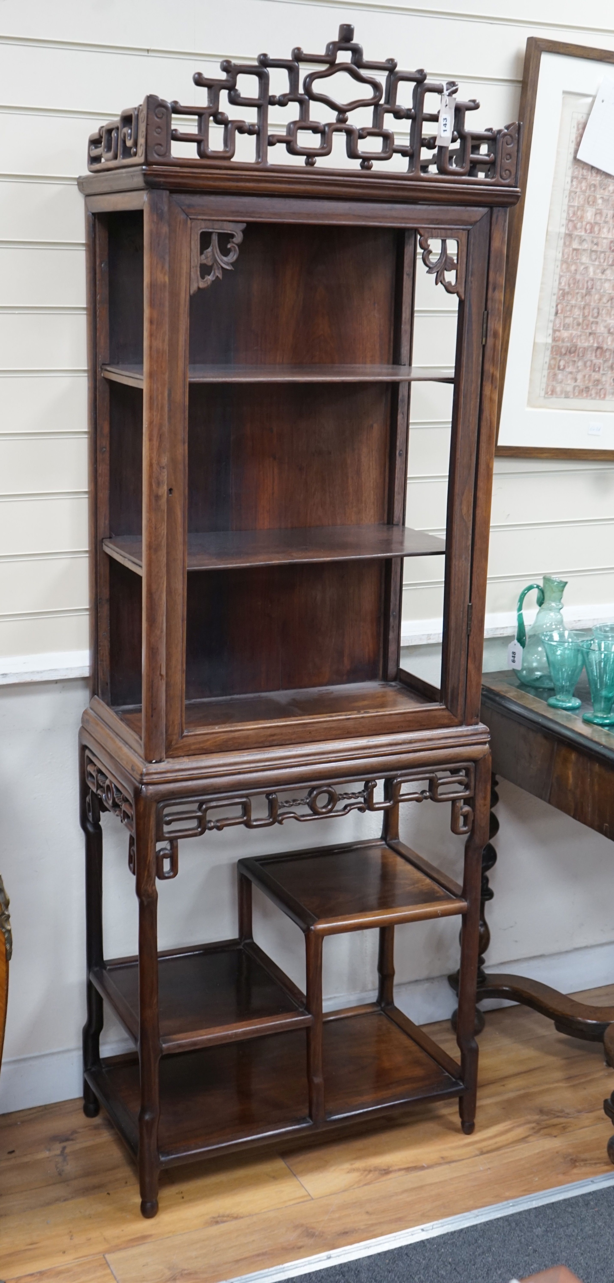 A Chinese hongmu cabinet on stand , circa 1900, lacking glazing, width 63cm, depth 35cm, height 185cm